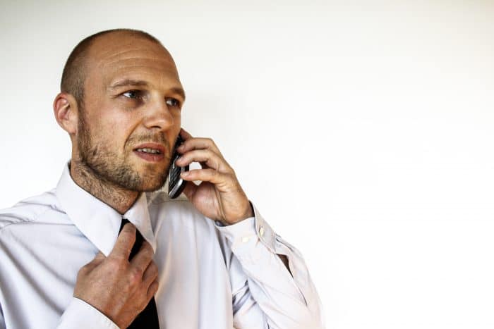 confused man holding phone